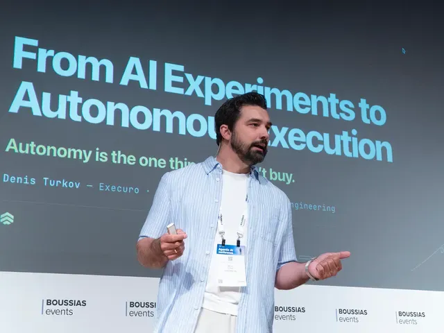 Denis Turkov on stage in Athens, presenting From AI Experiments to Autonomous Execution